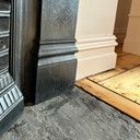 Skirting World Period MDF Skirting Board, close-up of black and white MDF skirting boards installed at the bottom of walls next to a wooden floor.
