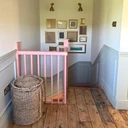 Skirting World Ogee 2 MDF Dado Rail, pink-painted staircase railing and wooden floor in a home interior.