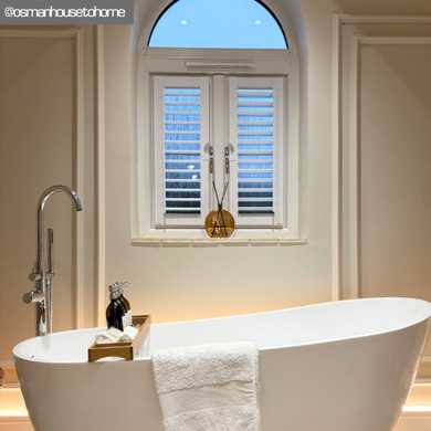 Skirting World Astragal Maxi MDF Panel Moulding, a decorative white MDF panel moulding with an astragal design is installed around a window in a modern bathroom.
