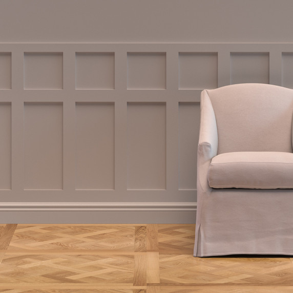 Skirting World Warwick Shaker MDF Half Wall Panelling Kit, beige wall paneling with a decorative grid pattern, and a cream armchair in a cozy interior setting.