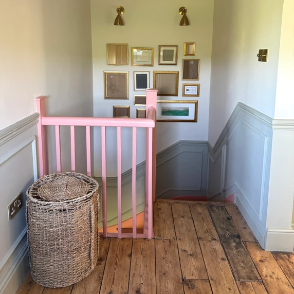 Skirting World Ogee 2 MDF Dado Rail, pink-painted staircase railing and wooden floor in a home interior.