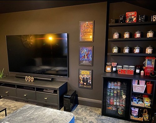 Cinema room with dark walls and black skirting boards throughout