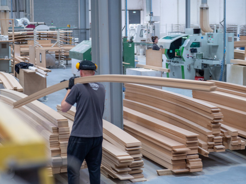 Skirting World machinist carrying MDF materials