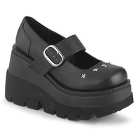 photo of black buckled platform mary jane shoes with star studs on the toe on a white background