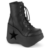 Black faux leather 7 eyelet lace up boots with a black  platform heel with a star shaped cutout are shown pointing right on a white background