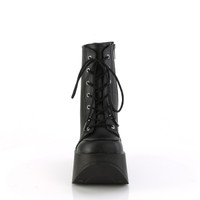 Black faux leather 7 eyelet lace up boots with a black  platform heel with a star shaped cutout are shown pointing straight on a white background
