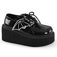 Black vinyl creeper style shoes with a black ridged platform heel and black and white bat wings attached to the laces are shown pointing right on a white background
