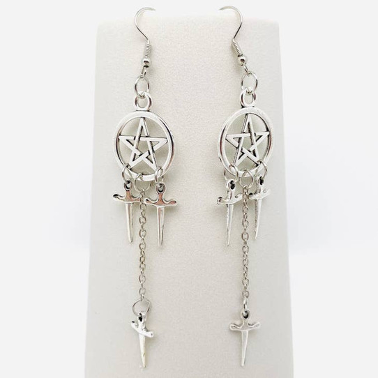 photo of a pair of pentagram earrings with dangling chains and daggers and french hooks on a white background