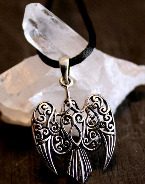 delicate filigree raven in sterling silver on a black satin cord