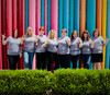 Group of moms proudly show off their pride socks shirt to show the support of the designer