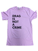 T-shirt with the phrase “Drag Is Not a Crime” displayed on a hanger at an LGBTQ+ market booth.