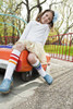 Kid laughing in bright Pride Socks, radiating joy and positivity
