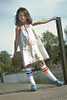 Close-up of rainbow tube socks on a child’s legs, full of color and confidence