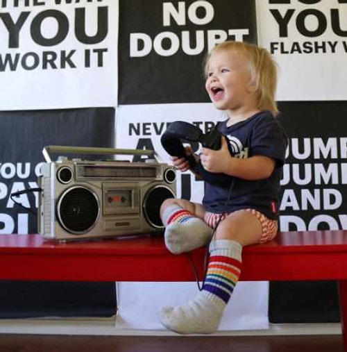 Toddler dressed in rainbow socks and matching playful outfit Toddler dressed in rainbow socks and matching playful outfit