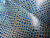 Close-up of Melody Frozen Crystal embossed leather showing geometric mosaic pattern and icy blue tones