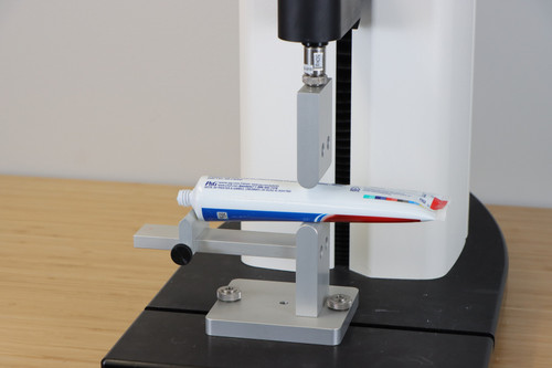 Tube Extrusion Jig measures the force needed to squeeze cream, paste or ointment out of a tube.