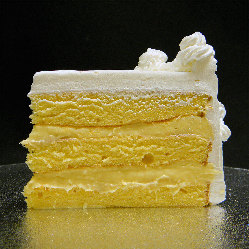 Original Rum: three moist layers of Yellow cake filled with signature Italian (non-alcoholic) Rum custard, frosted in Italian whipped cream.