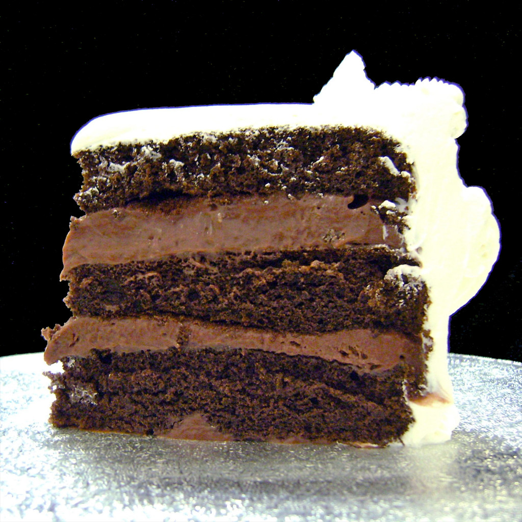 Chocolate Chocolate Rum: three moist layers of Chocolate cake filled with signature Italian (non-alcoholic) Chocolate Rum custard, frosted in Italian whipped cream.