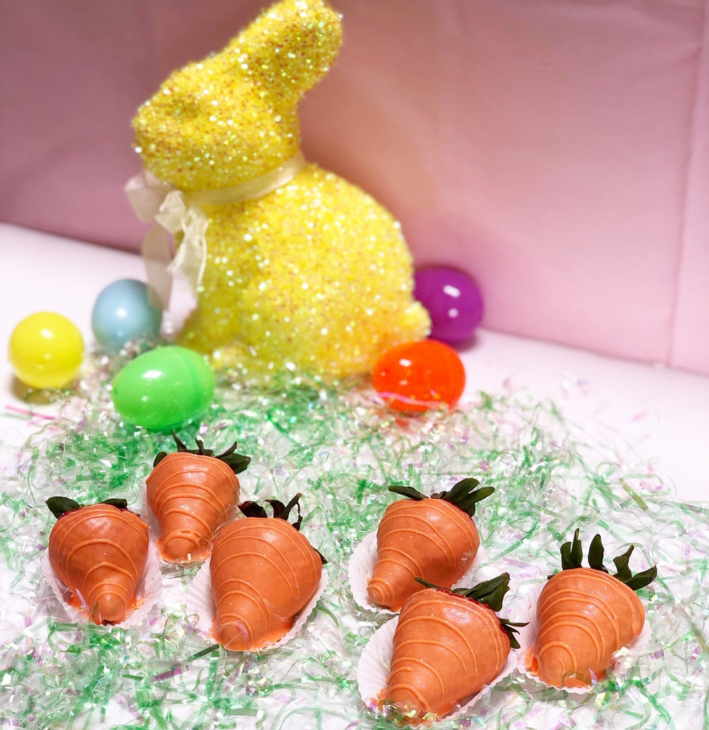Premium strawberries dipped in orange colored white chocolate ganache with edible glitter.