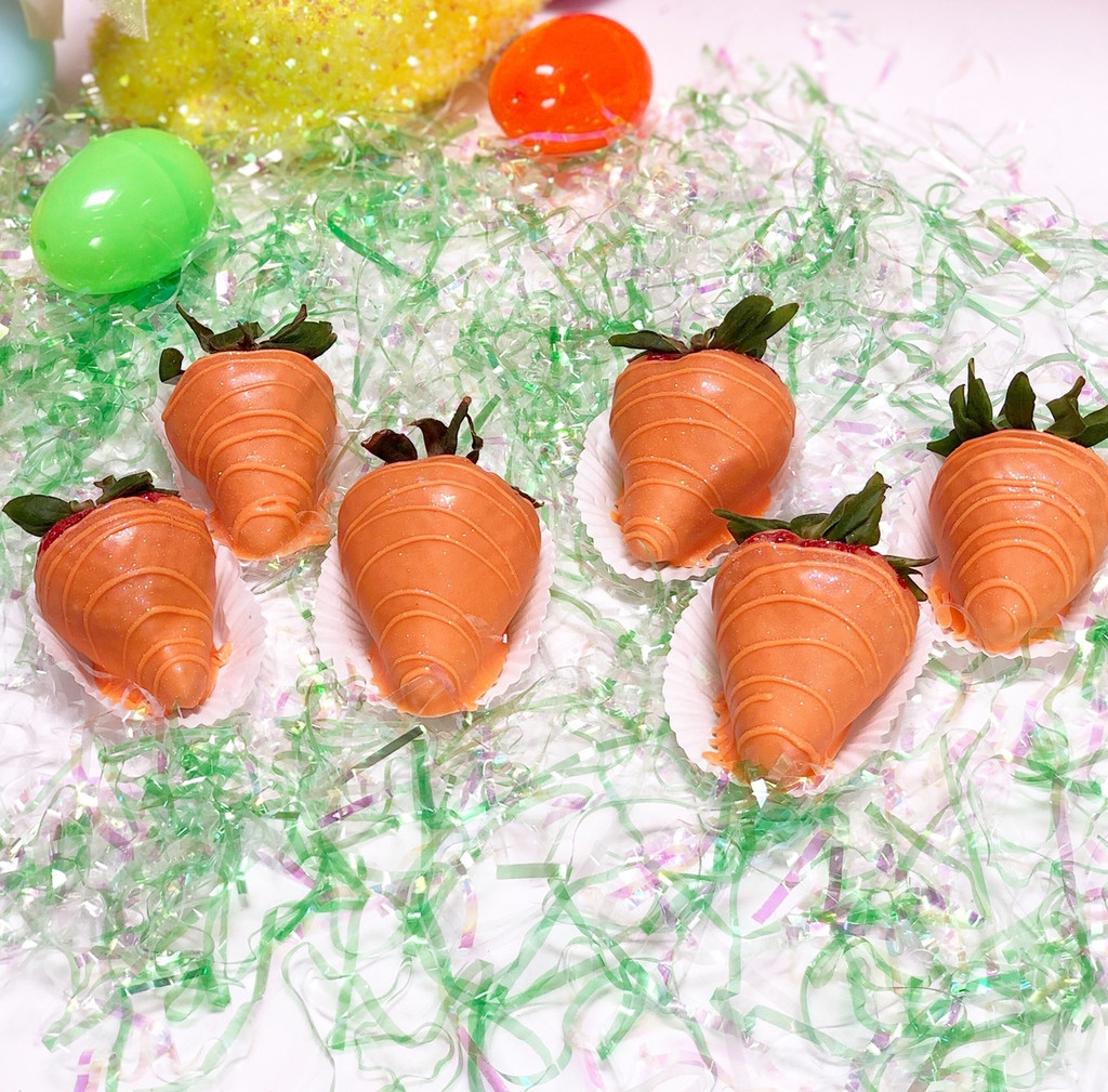 Premium strawberries dipped in orange colored white chocolate ganache with edible glitter.