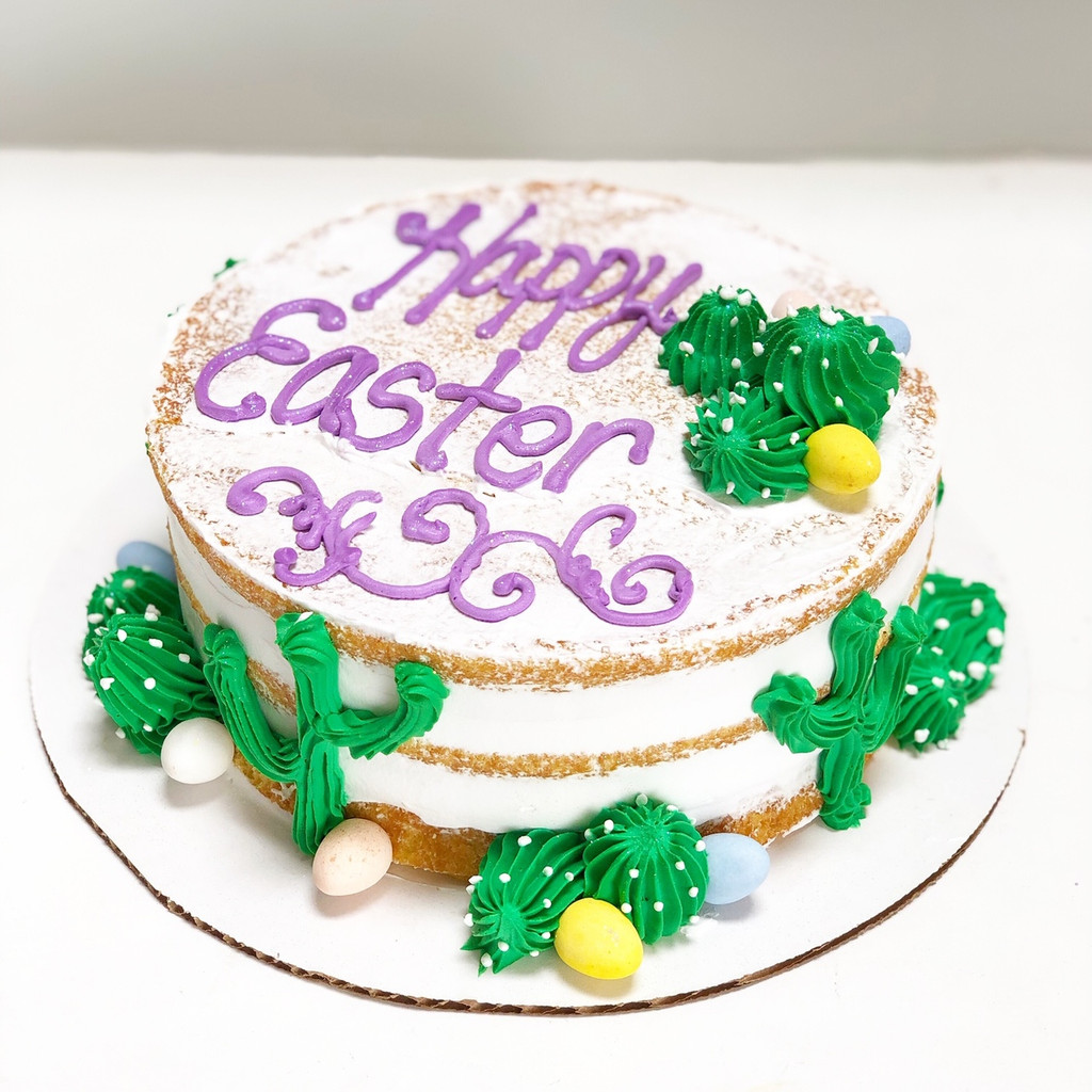 A depiction of Easter egg hunting in the desert with hand-piped cacti and Cadbury chocolate eggs.