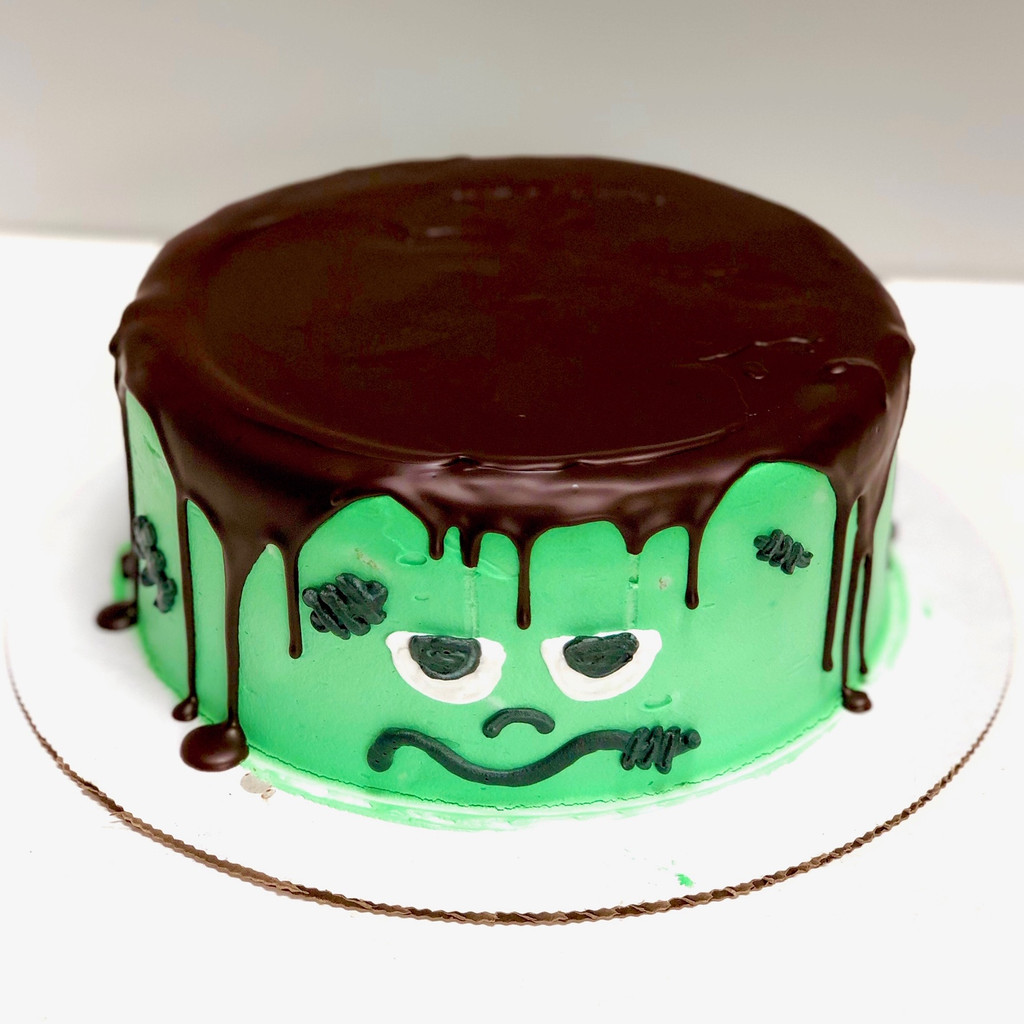 Dark chocolate ganache and green tinted whipped cream frosting.