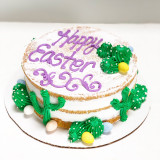 A depiction of Easter egg hunting in the desert with hand-piped cacti and Cadbury chocolate eggs.