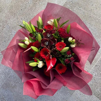 Beautiful ruby reds and whites in a hand tied bouquet