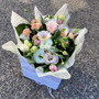 Seasonal pastel blooms in a carry bag