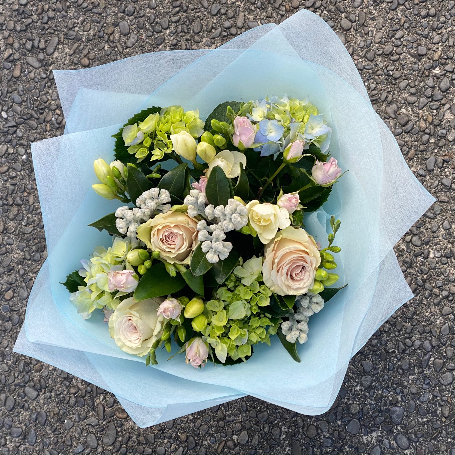 Crisp seasonal bouquet in fresh whites, greens and pale pinks. 