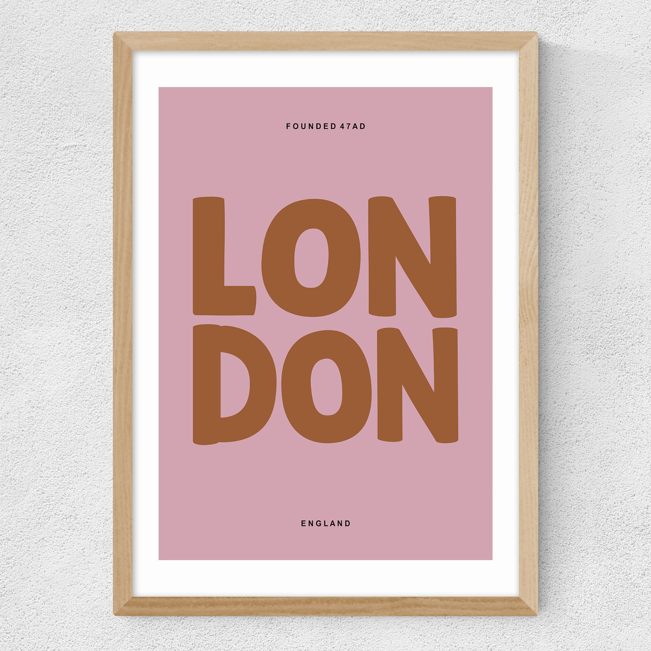 london typography pink art print by luxe poster co in oak frame