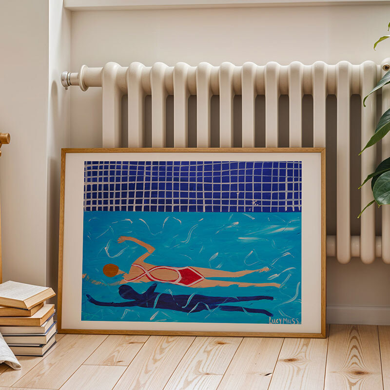 red swimmer art print by the lucy muss in oak frame