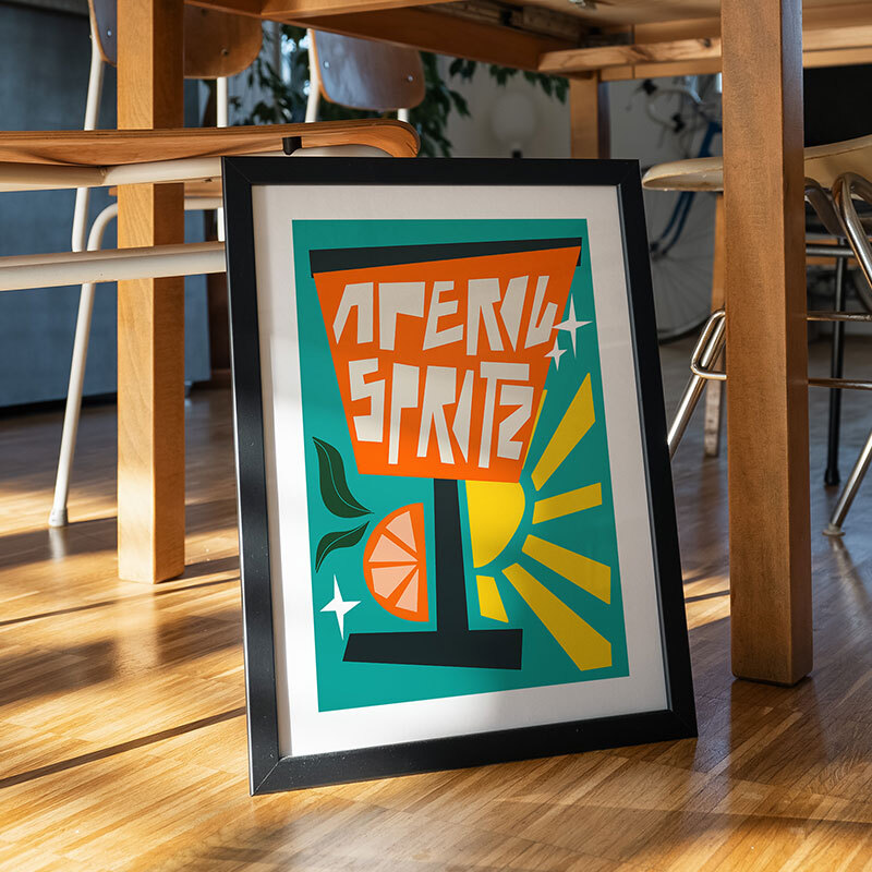 Aperol spritz blue art print by natalie cass in black frame
