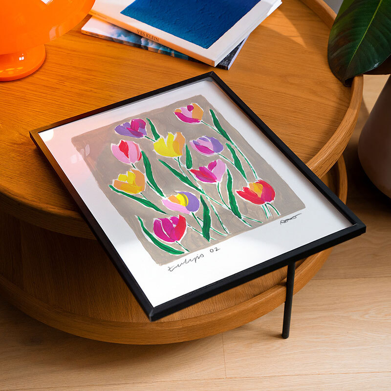 Tulip field art print by natalie cass in black frame.