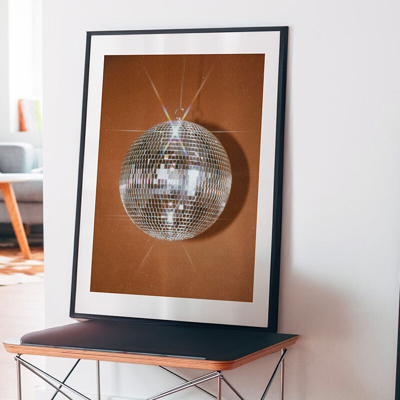 disco ball orange art print by sammy hearn in black frame