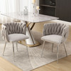Modern handwoven dining chairs with silver legs, armrests, and high-density cushion.