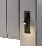 The bedside features a rotating reading light