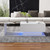 A coffee table with a glass top, storage drawers, and RGB LED lighting. A coffee table with a glass top, storage drawers, and RGB LED lighting.
