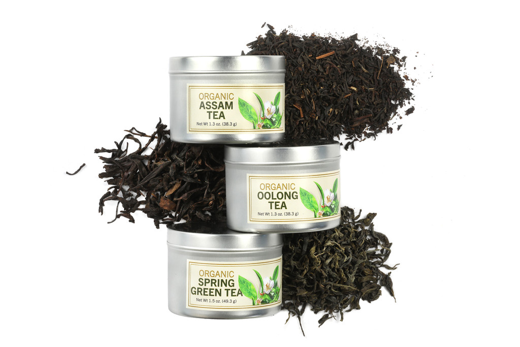 Three small tins labeled Assam Tea, Oolong Tea, and Spring Green Tea