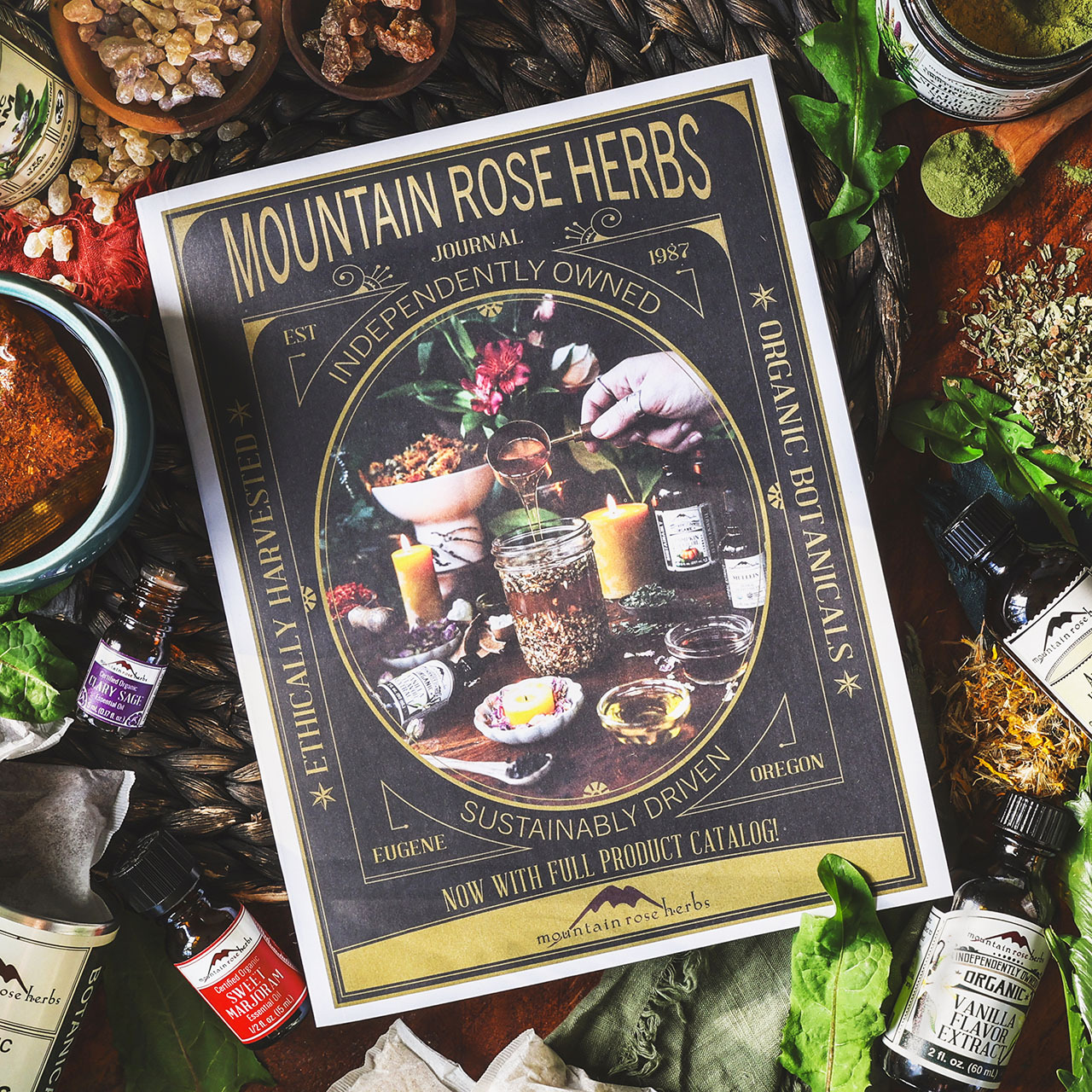 2026 Mountain Rose Herbs Journal Cover surrounded by herbs, spices, essential oils, and resins. 