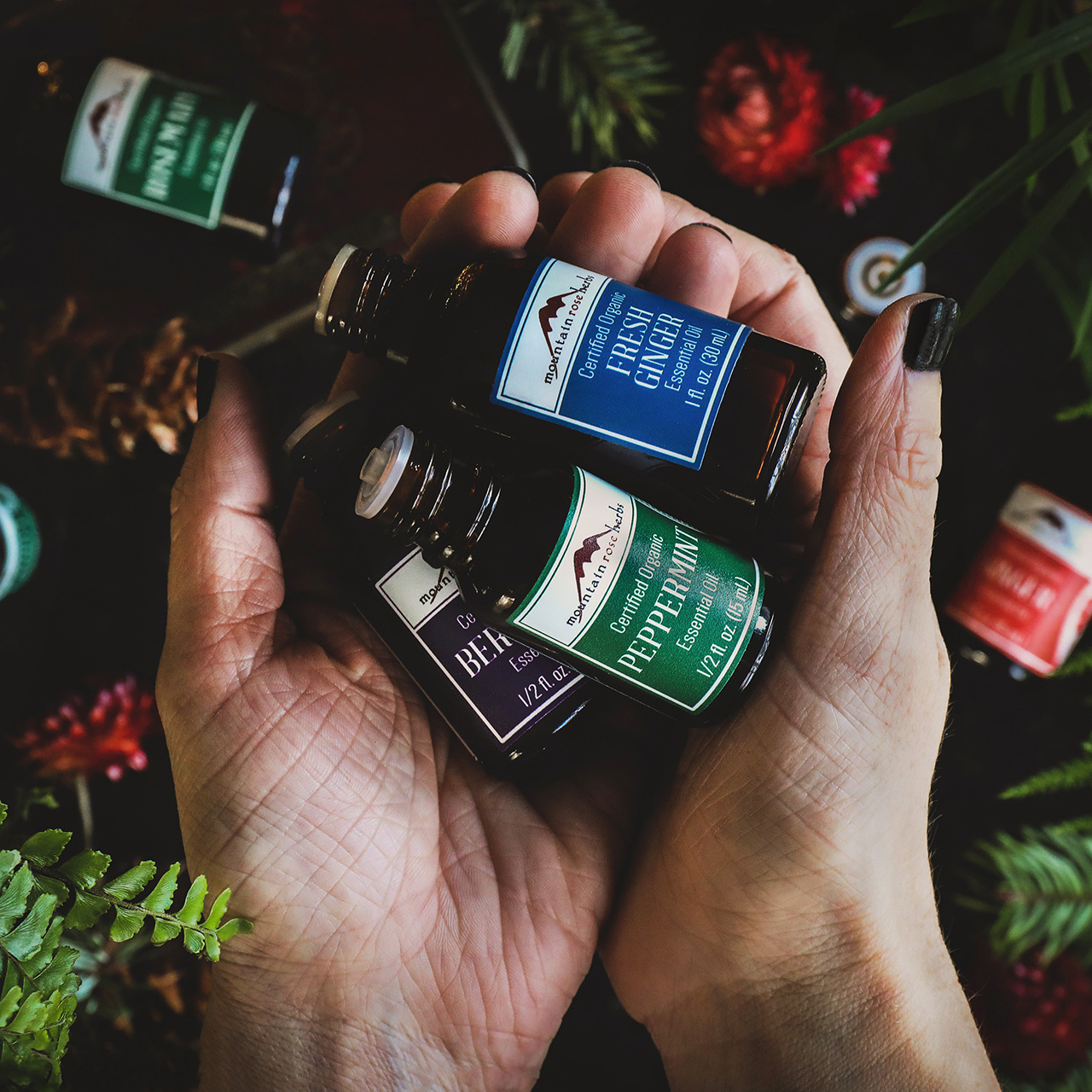 Hand holding essential oil bottles 
