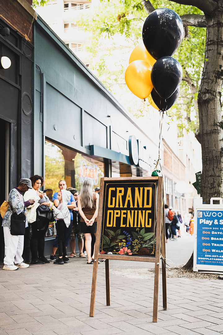 Grand Opening sign and line of patrons outside our Seattle store on opening day