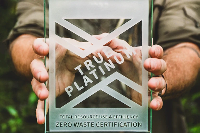 Hands holding Zero Waste Award