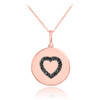 Heart disc pendant necklace with black diamonds in 14k rose gold.