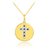 Cross disc pendant necklace with diamonds and sapphire in 14k gold.