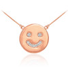 Smiley face disc necklace with diamonds in 14k rose gold.