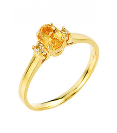 Citrine November birthstone and white topaz gemstone ring in gold.