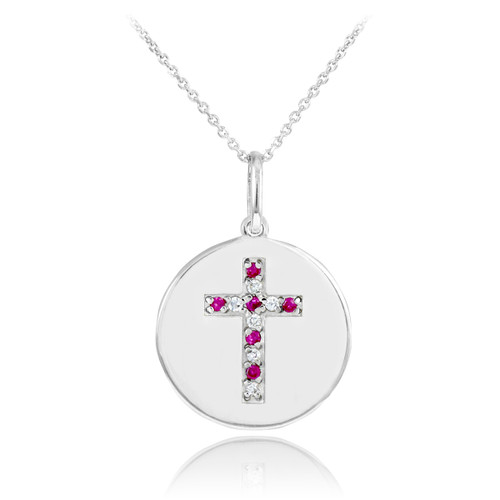 Cross disc pendant necklace with diamonds and rubies in 14k white gold.
