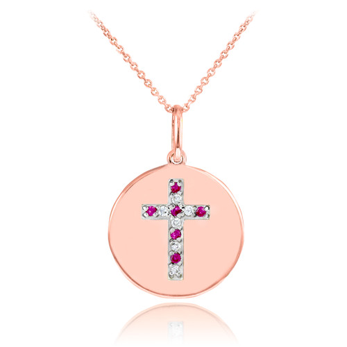Cross disc pendant necklace with diamonds and rubies in 14k rose gold.