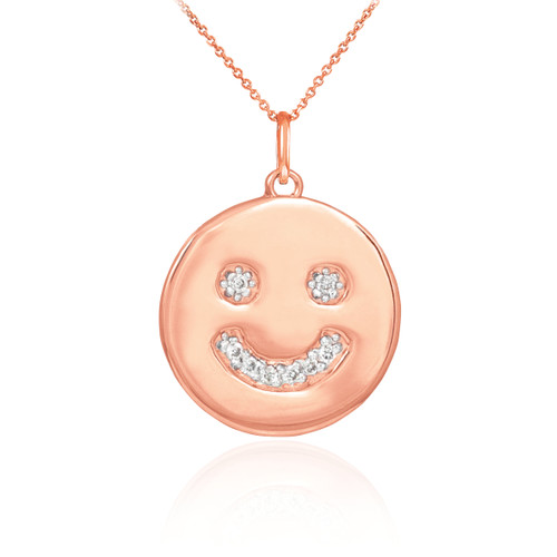 Smiley face disc pendant necklace with diamonds in 14k rose gold.